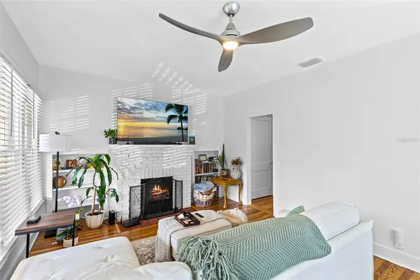 a living room with furniture and a fireplace