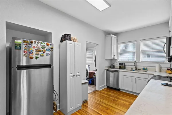 a kitchen with stainless steel appliances granite countertop a refrigerator and a sink