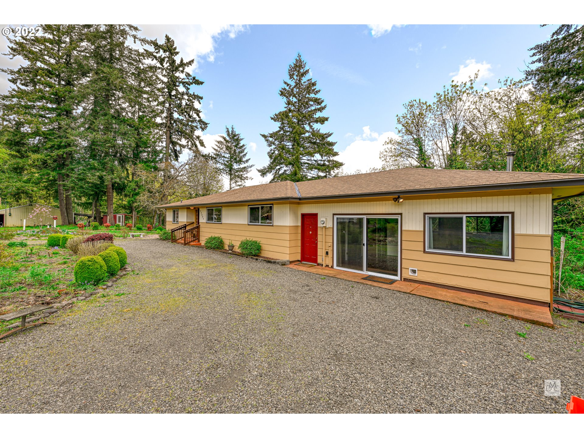 22496 South Bartholomew Road Estacada, OR 97023 - Photo 3 of 32 a front view of a house with a garden