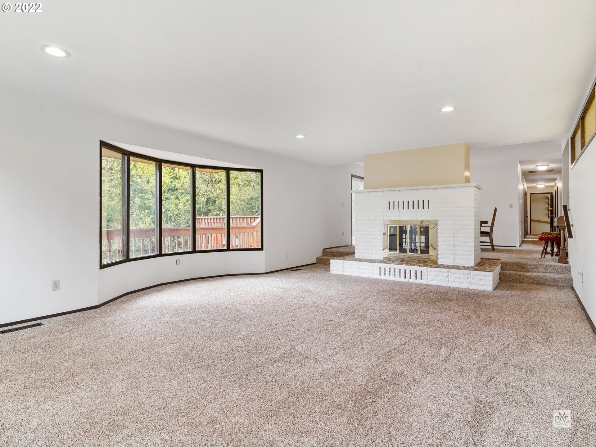 22496 South Bartholomew Road Estacada, OR 97023 - Photo 6 of 32 a view of an empty room with a fireplace and a large window
