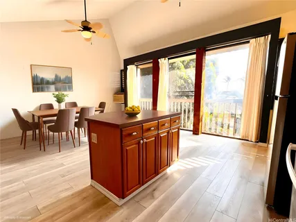 a view of a dining room with furniture a chandelier and wooden floor