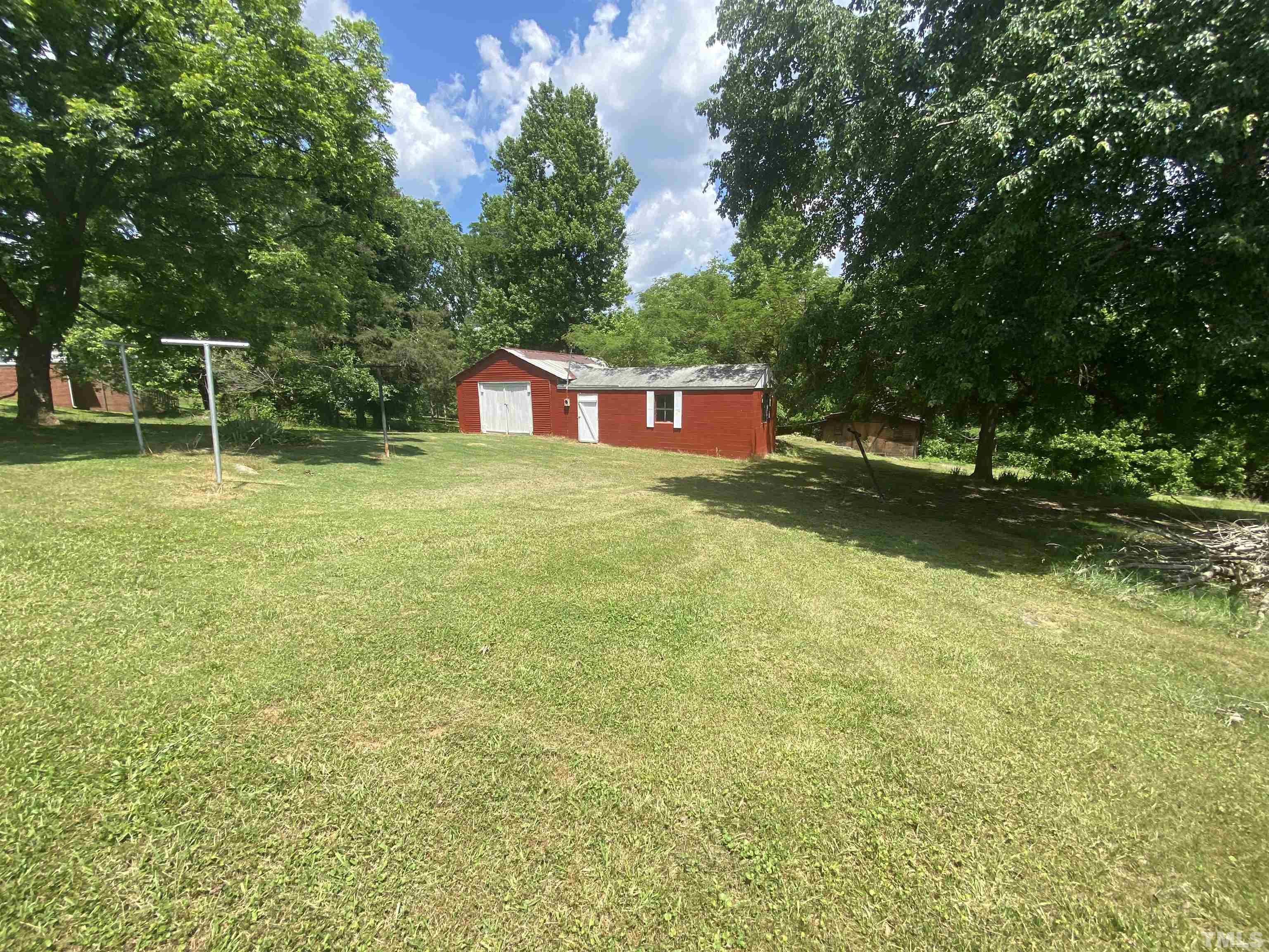 302 Allgood Street Roxboro, NC 27573 - Photo 20 of 30 a backyard of a house with swimming pool and trees