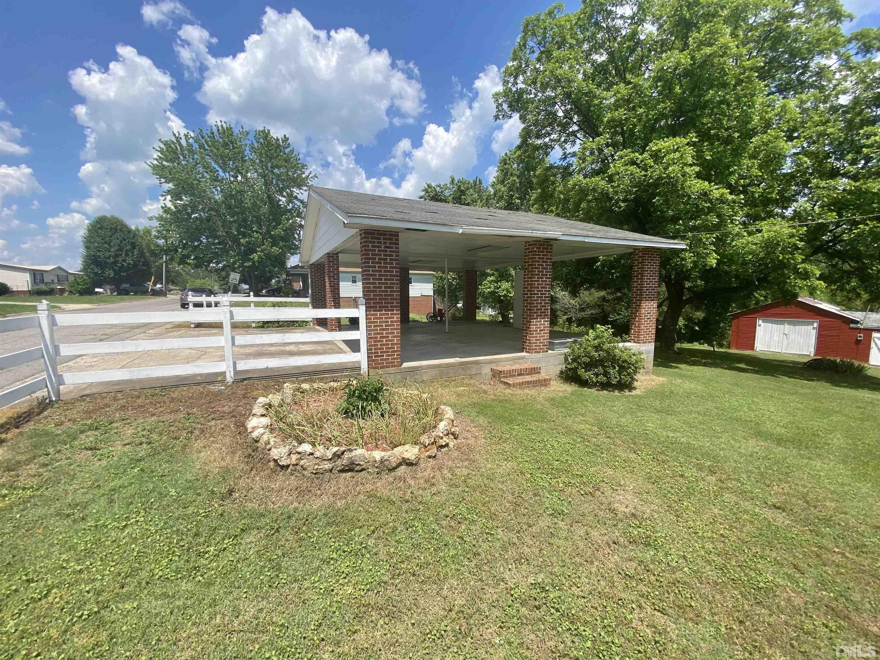 302 Allgood Street Roxboro, NC 27573 - Photo 26 of 30 a backyard of a house with garden and barbeque oven