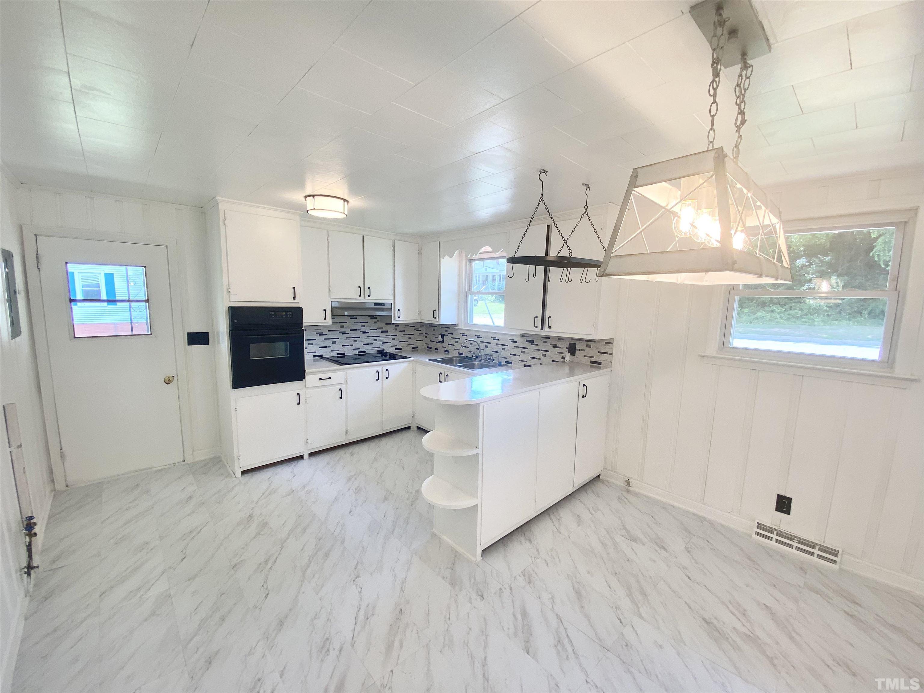 302 Allgood Street Roxboro, NC 27573 - Photo 4 of 30 a kitchen with a sink cabinets and window