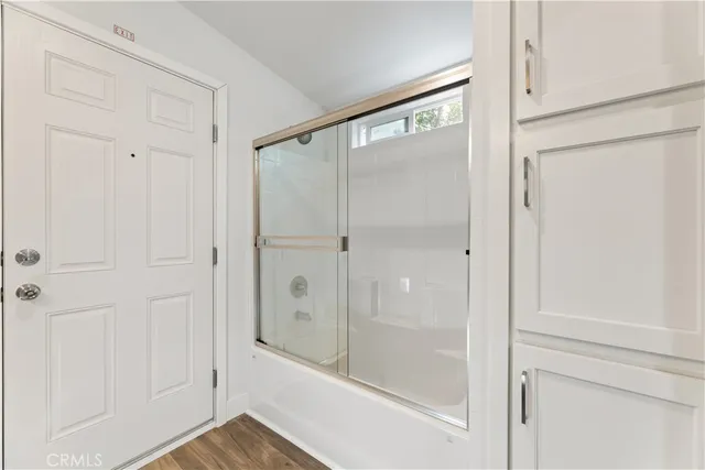 a bathroom with a glass shower door