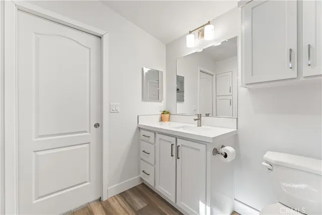 a bathroom with a sink toilet and a mirror