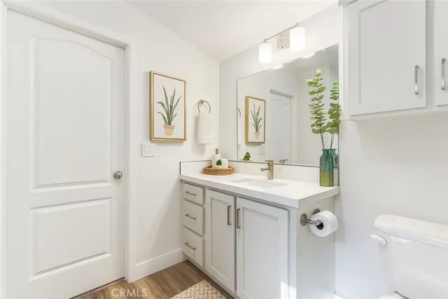 a bathroom with a sink a toilet and mirror