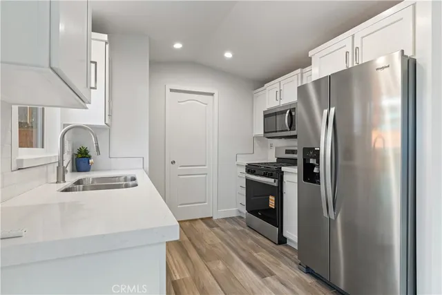 a kitchen with a refrigerator and a sink