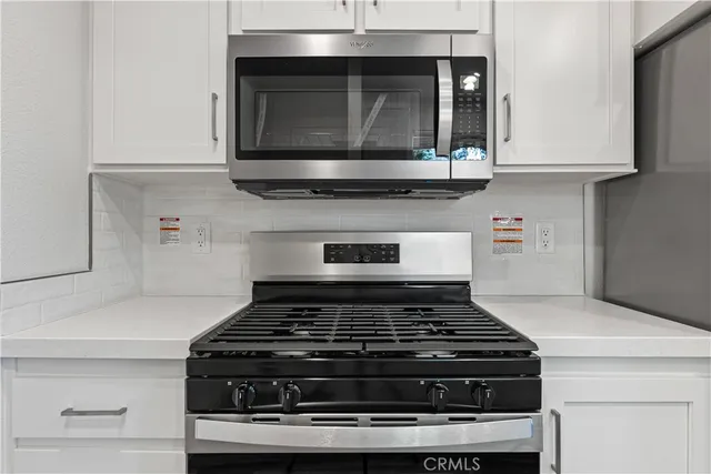a stove top oven sitting inside of a kitchen