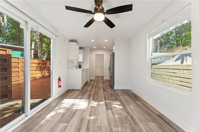 a view of a room with wooden floor and windows