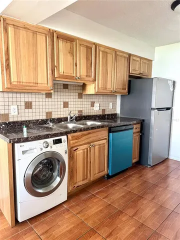 a kitchen with a sink a washer and dryer
