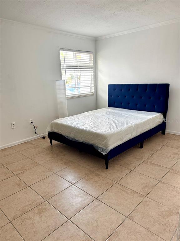 13300 Walsingham Road, Unit 161 Largo, FL 33774 - Photo 8 of 21 a bedroom with a bed and window