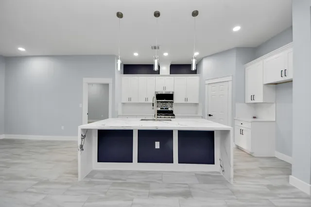 a kitchen with a sink stove and microwave