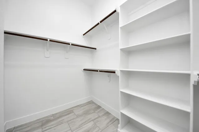 a bathroom with a tub a sink and mirrors