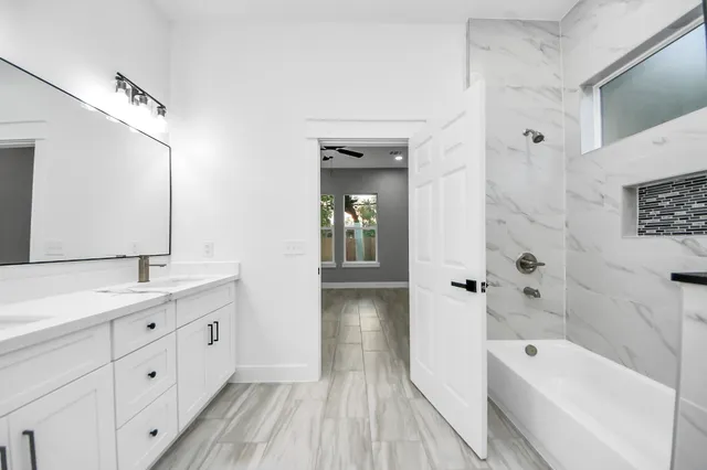 a bathroom with mirror cabinets and a sink