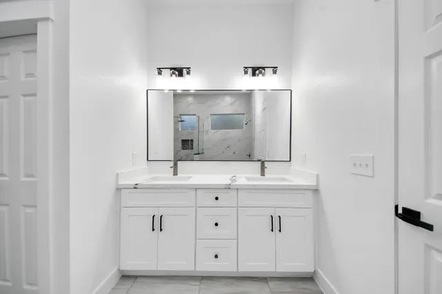 a spacious bathroom with a double vanity sink mirror and