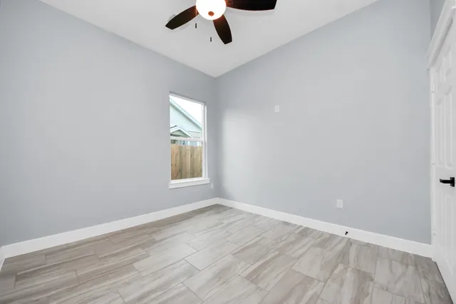 wooden floor in an empty room with a window