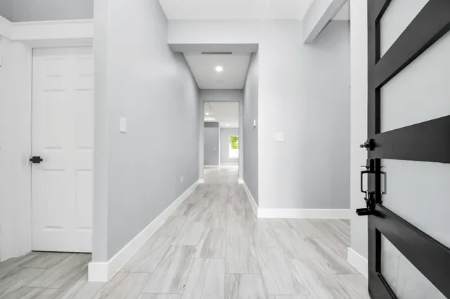 a view of a hallway view with wooden floor and staircase