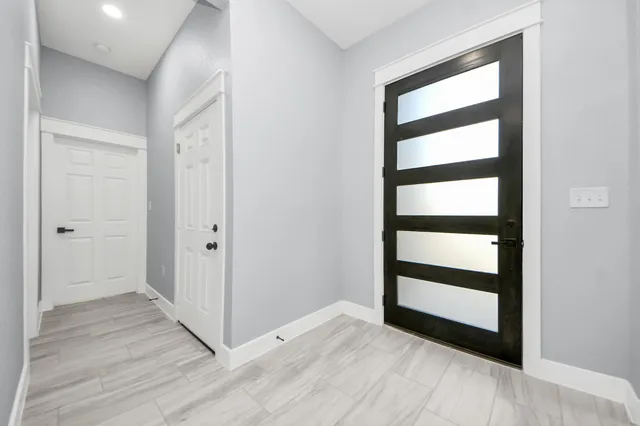 a view of front door with wooden floor