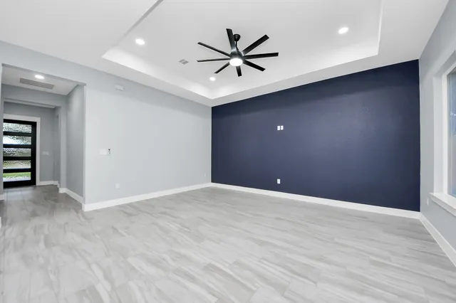 a view of an empty room with a ceiling fan