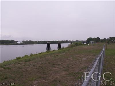1651 Sessler Road Alva, FL 33920 - Photo 4 of 6 a view of a lake with houses in the back