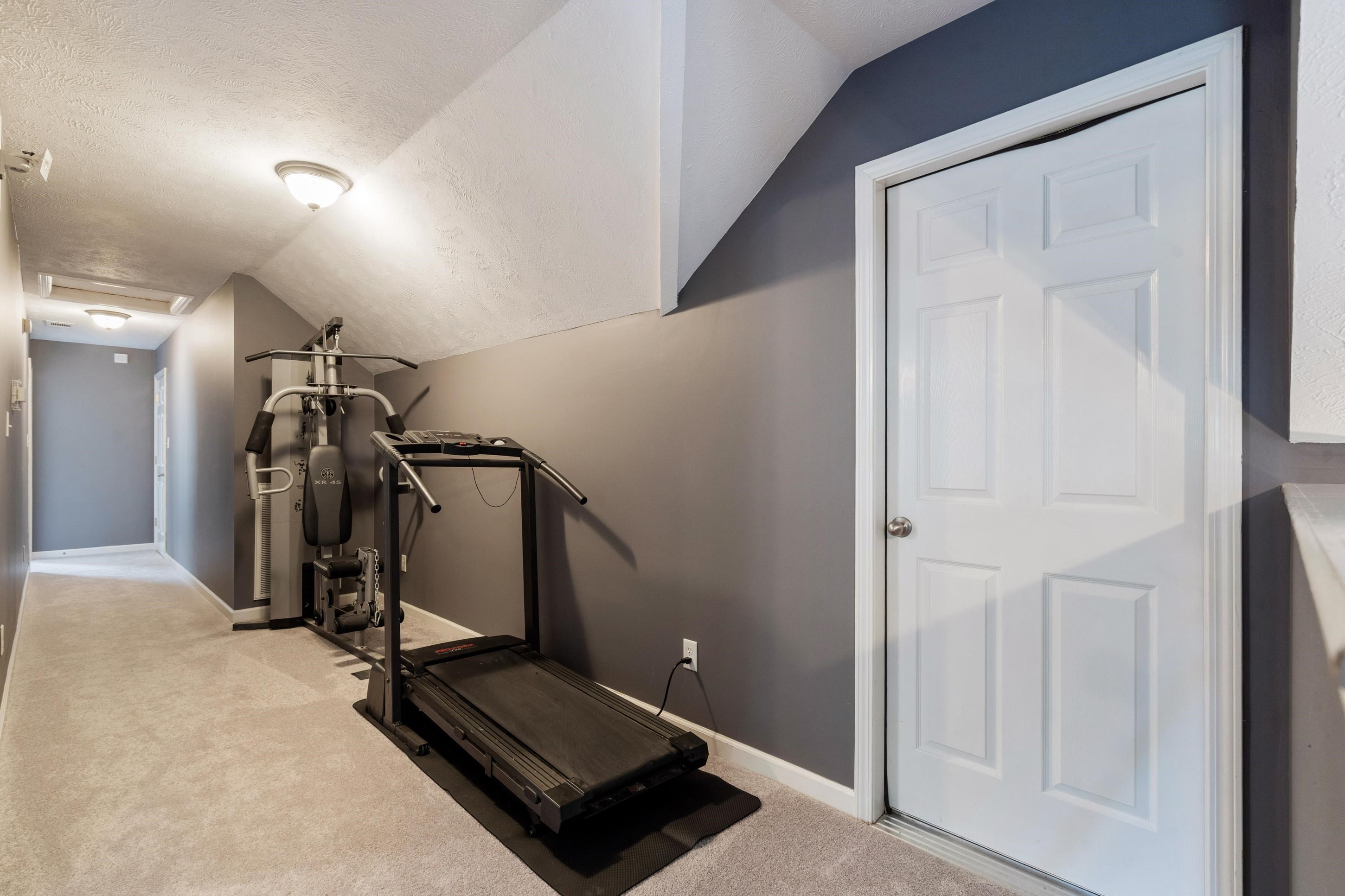 7757 Brunswick Road Millington, TN 38053 - Photo 18 of 40 Carpeted hallway featuring a paneled interior door, sloped ceilings, recessed lighting, and neutral wall tones