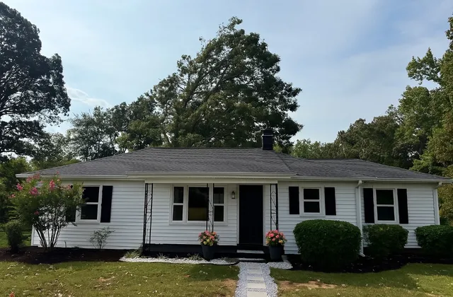a view of a house with swimming pool and a yard