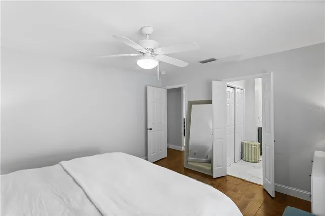 a bedroom with a large bed and a chandelier