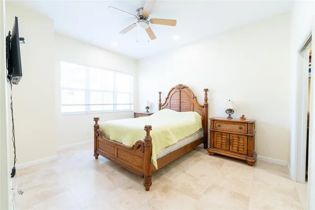 a bed sitting in a bedroom next to a window
