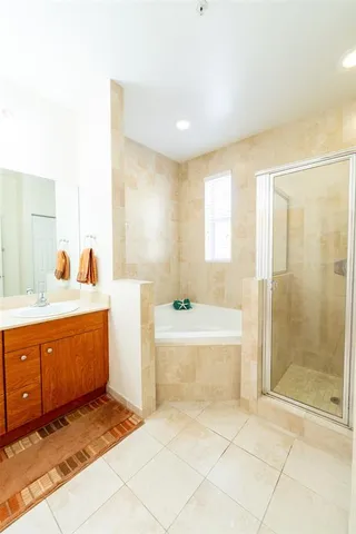 a bathroom with a tub sink and mirror