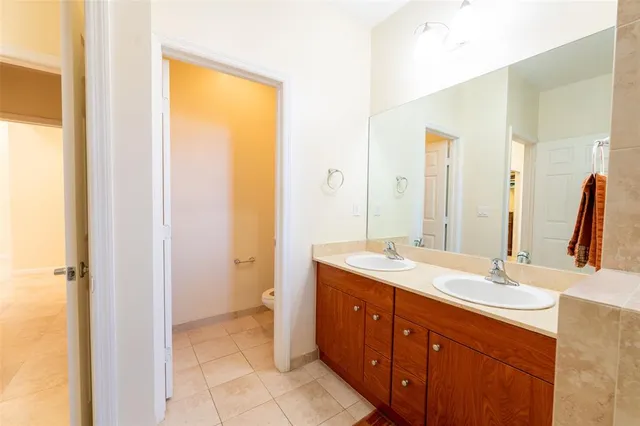 a bathroom with a double vanity sink mirror and shower