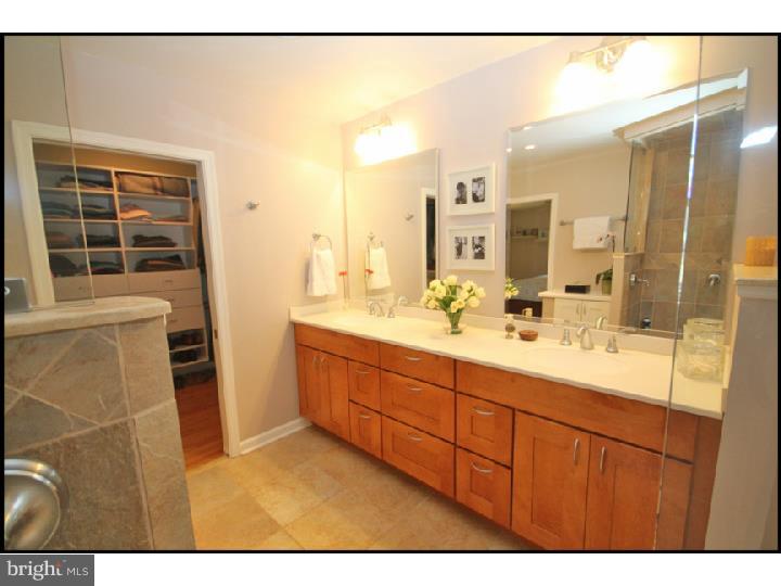 1028 Millbrook Road Berwyn, PA 19312 - Photo 17 of 25 a bathroom with a double vanity sink and a mirror