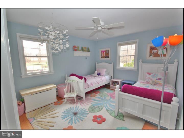 1028 Millbrook Road Berwyn, PA 19312 - Photo 19 of 25 a bedroom with furniture and a chandelier