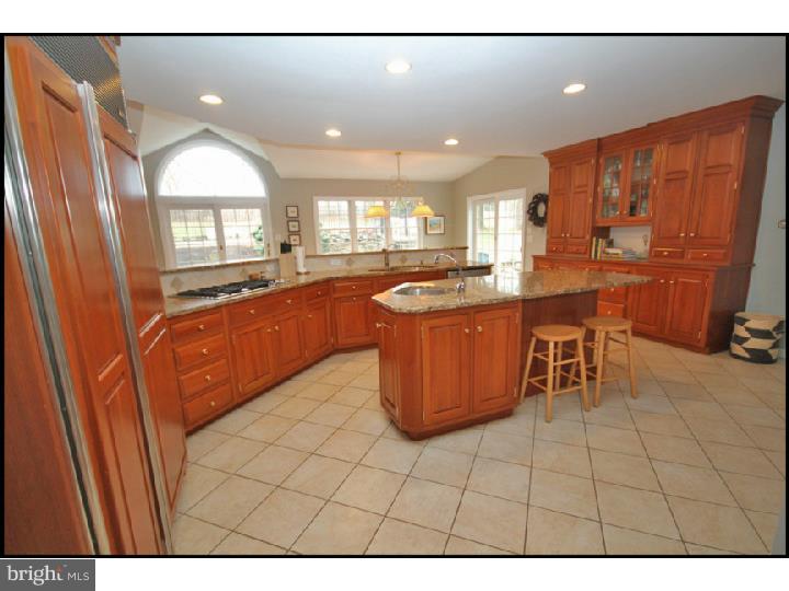 1028 Millbrook Road Berwyn, PA 19312 - Photo 7 of 25 a kitchen with stainless steel appliances granite countertop a sink and cabinets