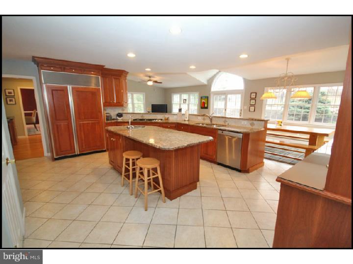 1028 Millbrook Road Berwyn, PA 19312 - Photo 8 of 25 a kitchen with stainless steel appliances granite countertop a sink and a refrigerator