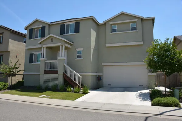 a front view of a house with garage