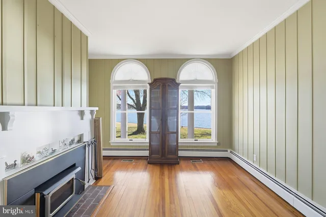 a room with a floor to ceiling windows and pool table