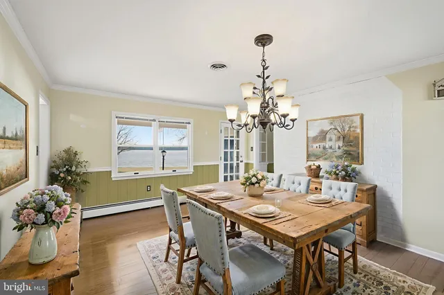 a kitchen with granite countertop white cabinets stainless steel appliances a sink and a window