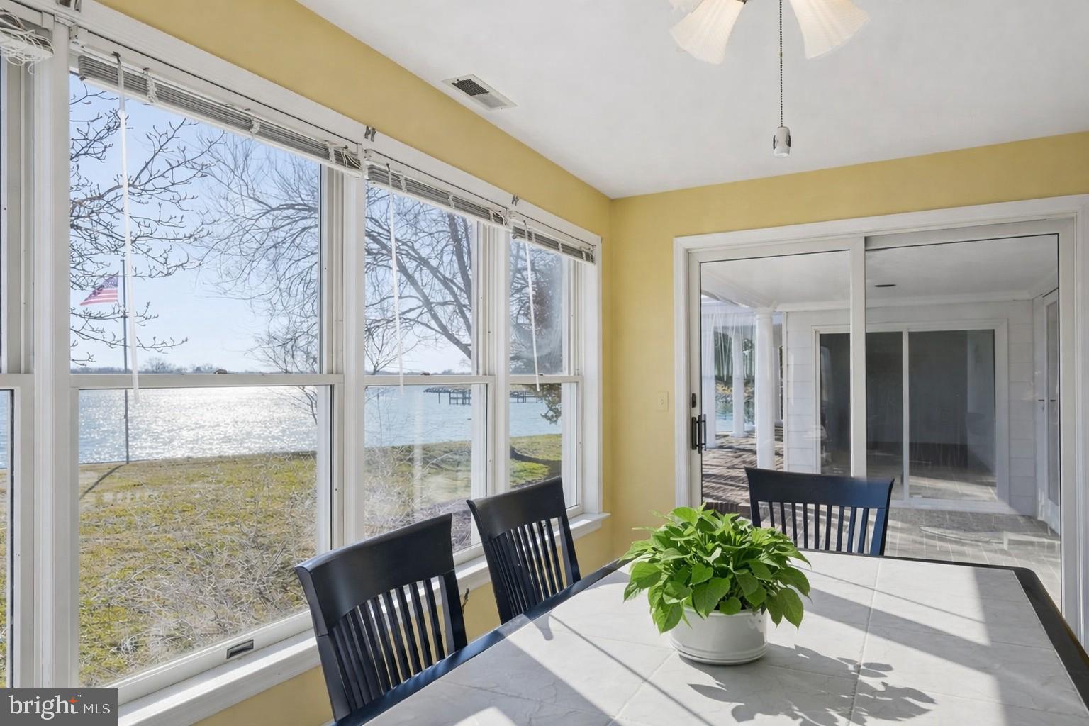 8515 Deep Cove Road Easton, MD 21601 - Photo 23 of 55 a view of a porch with chairs and potted plants