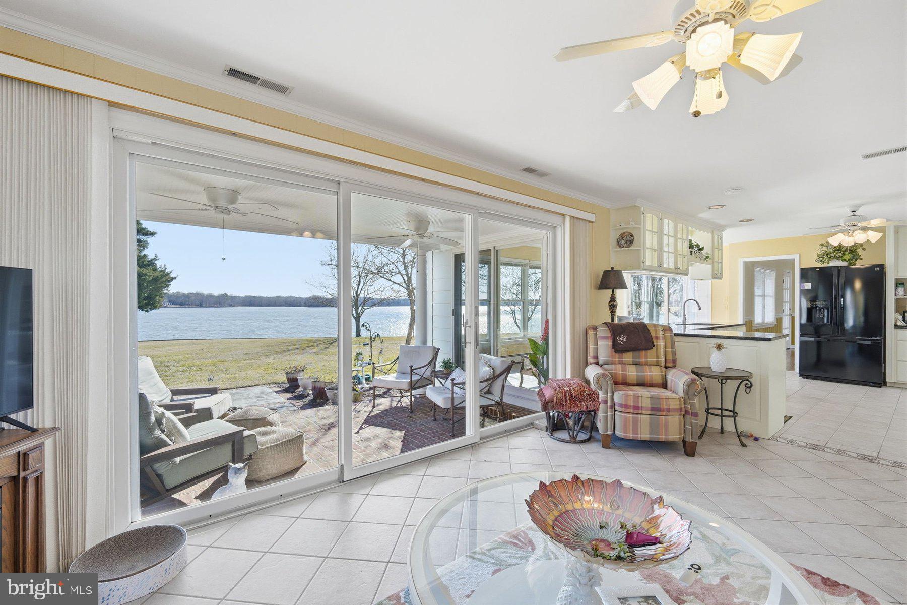 8515 Deep Cove Road Easton, MD 21601 - Photo 24 of 55 a living room with furniture and a floor to ceiling window