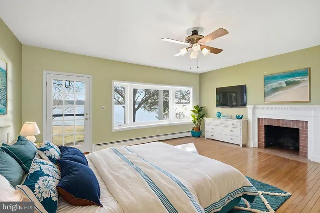 a bedroom with two beds and painting on the wall