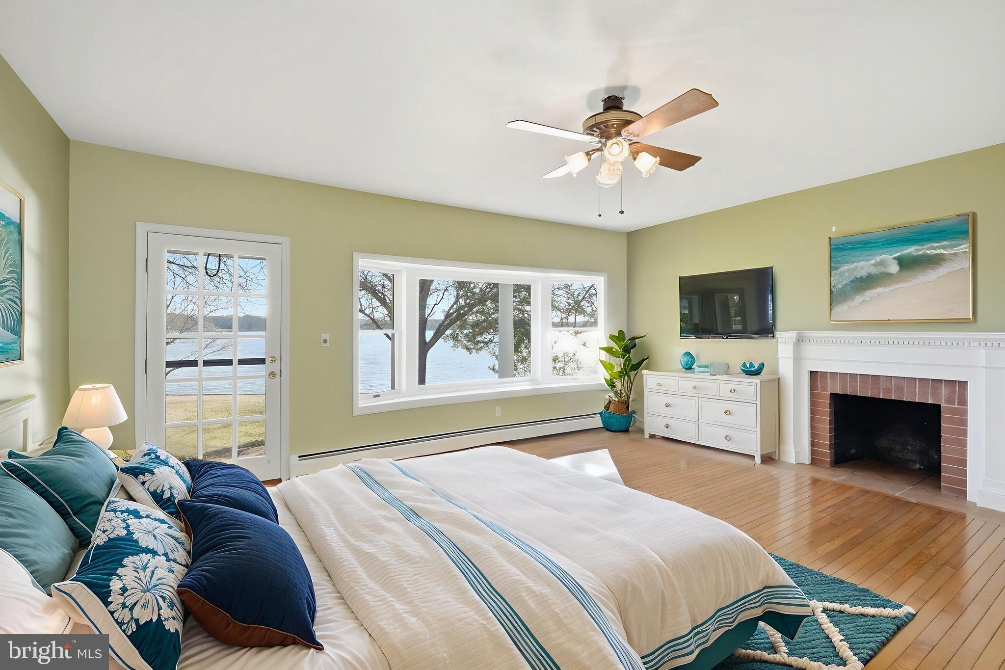 8515 Deep Cove Road Easton, MD 21601 - Photo 27 of 55 a bedroom with a large bed and a chandelier