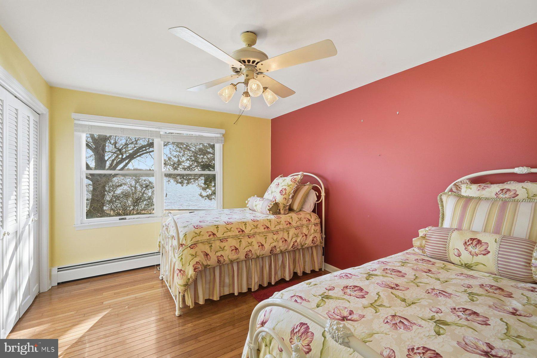 8515 Deep Cove Road Easton, MD 21601 - Photo 30 of 55 a bedroom with two beds and painting on the wall