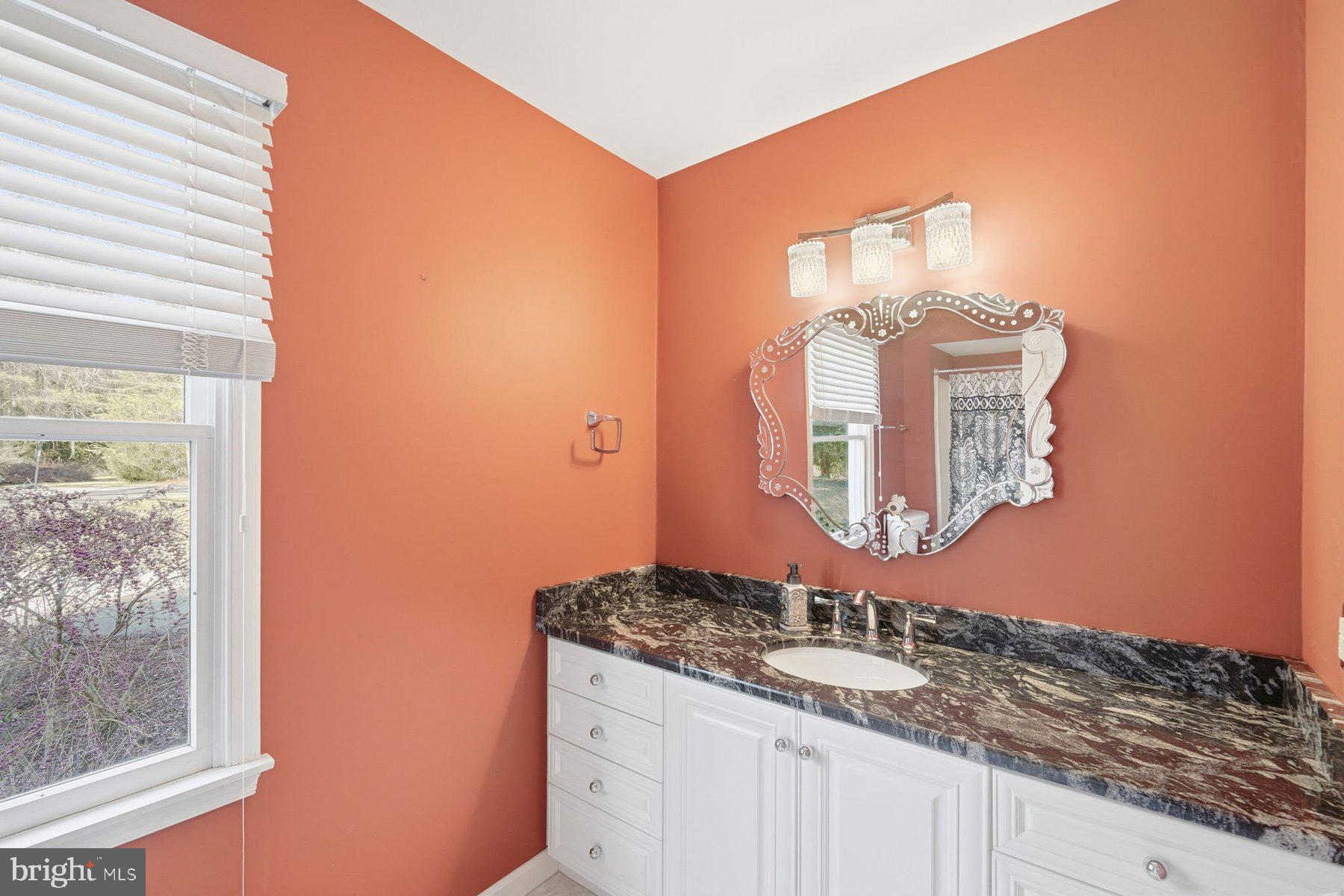 8515 Deep Cove Road Easton, MD 21601 - Photo 31 of 55 a bathroom with a granite countertop sink and a mirror