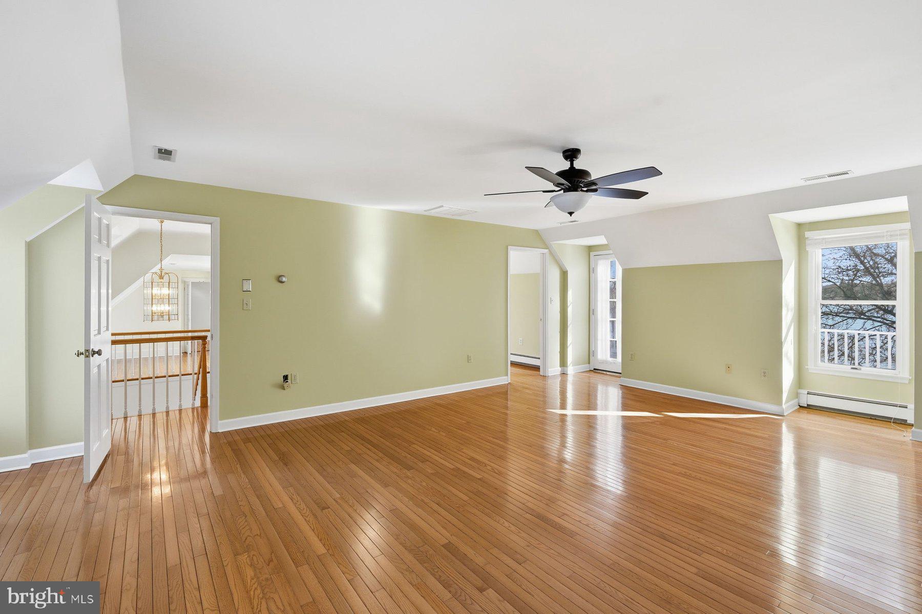 8515 Deep Cove Road Easton, MD 21601 - Photo 36 of 55 a view of empty room with wooden floor and fan