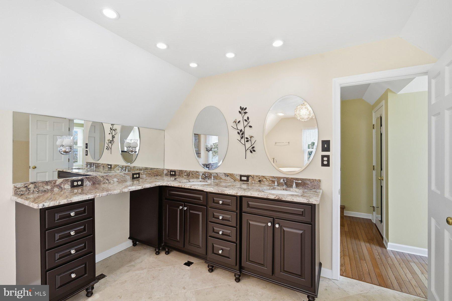 8515 Deep Cove Road Easton, MD 21601 - Photo 37 of 55 a spacious bathroom with a granite countertop double vanity and a mirror