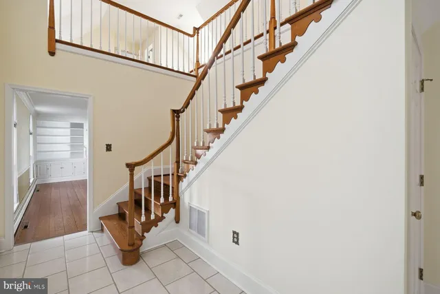 a view of entryway with wooden floor and stair