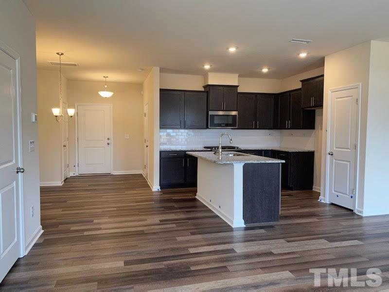 407 Vassar Drive Durham, NC 27713 - Photo 2 of 9 a large kitchen with kitchen island a sink stainless steel appliances and cabinets