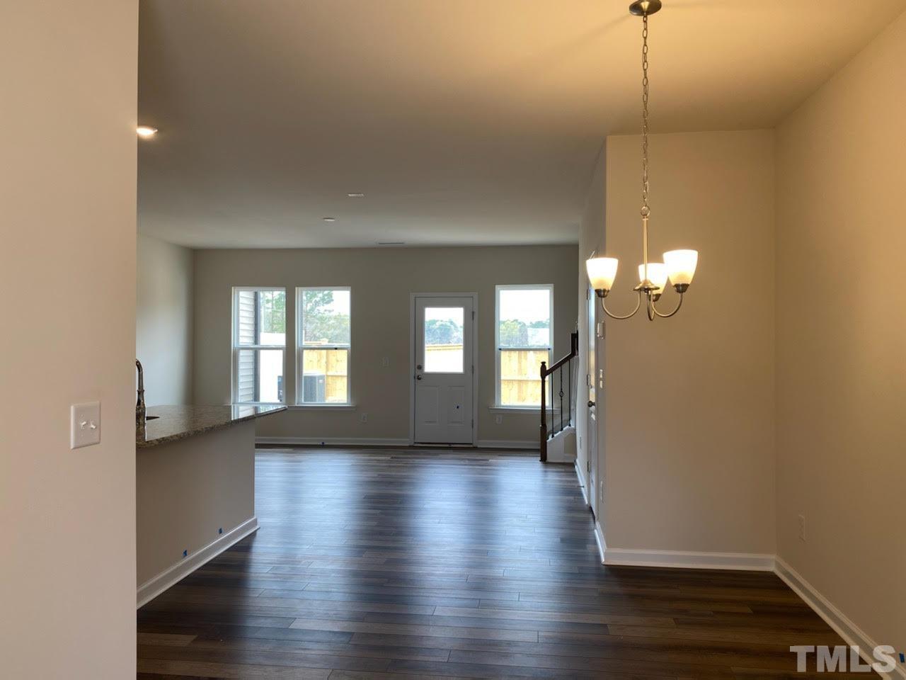 407 Vassar Drive Durham, NC 27713 - Photo 3 of 9 a view of an empty room with wooden floor and a window