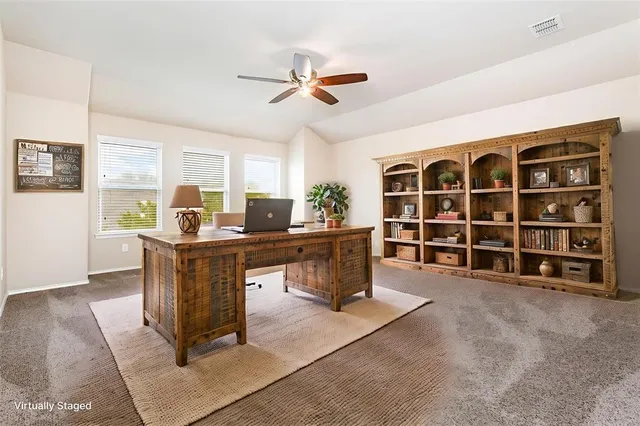 an empty room with a window and a ceiling fan
